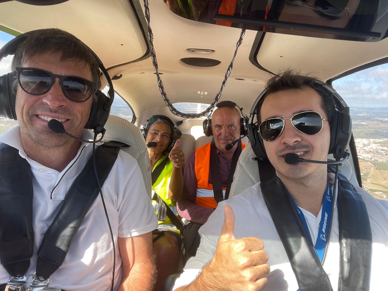A passenger and crew member smiling inside a SkyFuns flight
