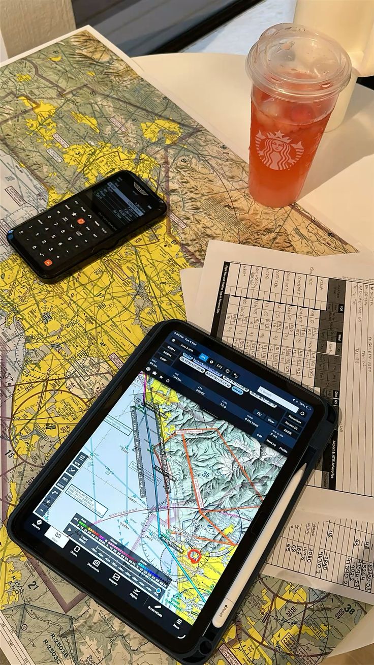 Tablet, chart, and navigation notes arranged for flight planning.